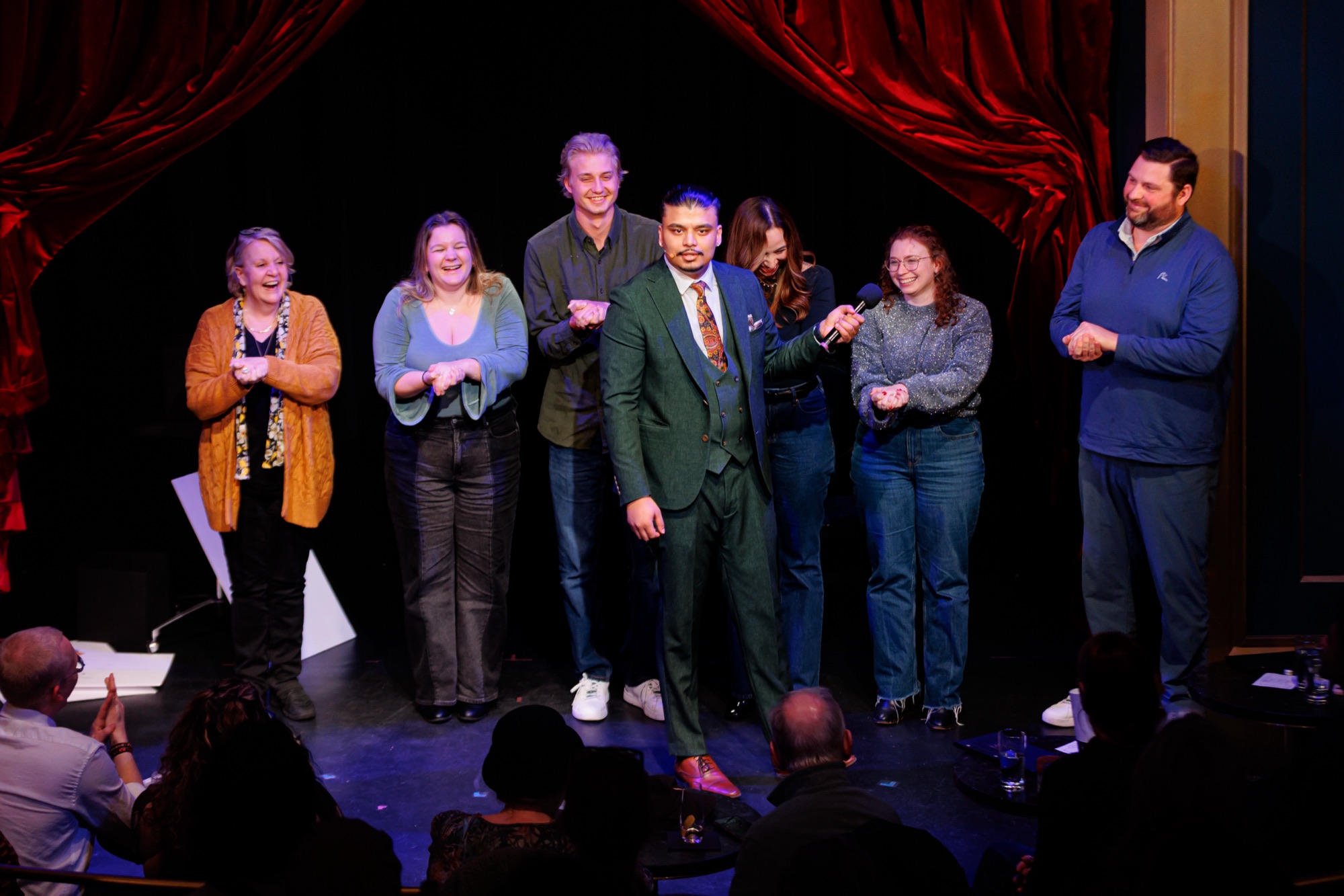 Volunteers on stage with Savio during a show.